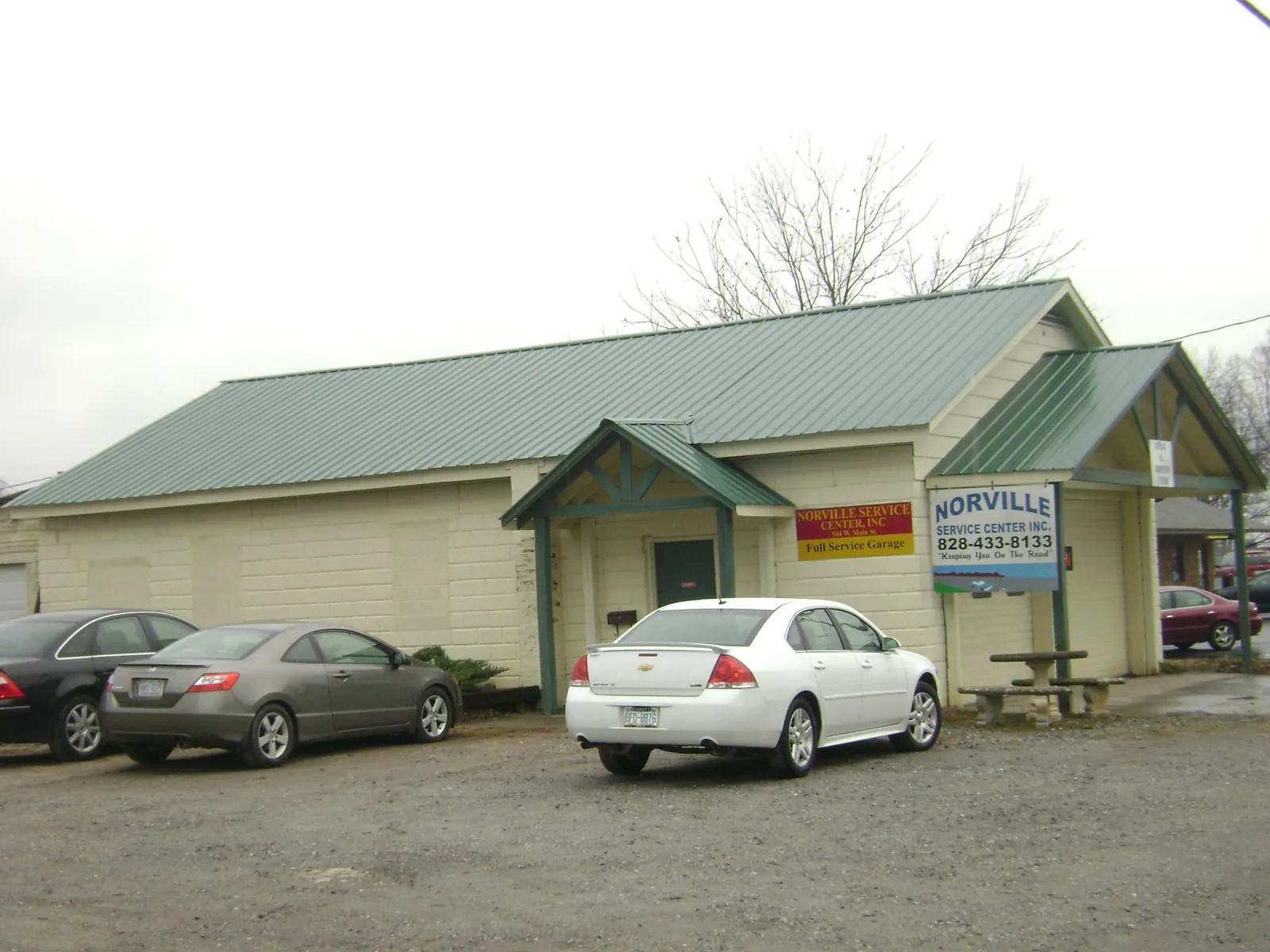Green metal roof on a service garage with a covered entry in Marietta